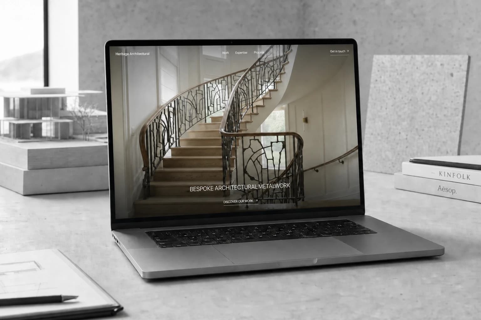 Heritage Architectural website displayed on a laptop in an architectural studio
