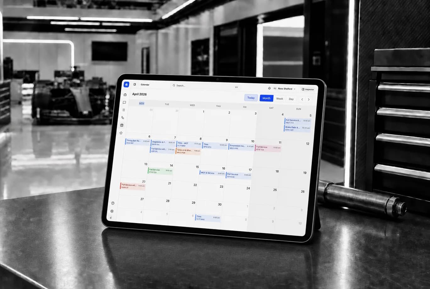 Pistonlog workshop calendar displayed on a tablet in a garage